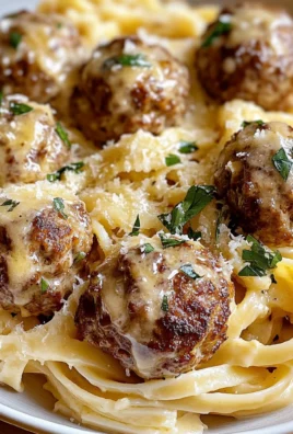 Easy Garlic Butter Meatballs Served Over Creamy Parmesan Linguine
