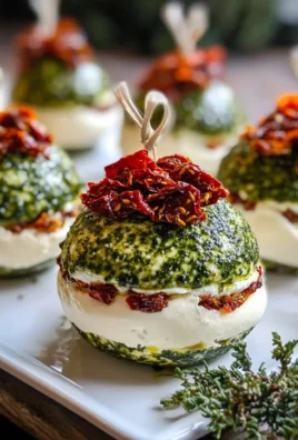 Festive Holiday Ornament Cheese Balls with Pesto & Sun-Dried Tomato Layers